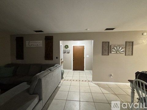 A living room with a couch and a door.