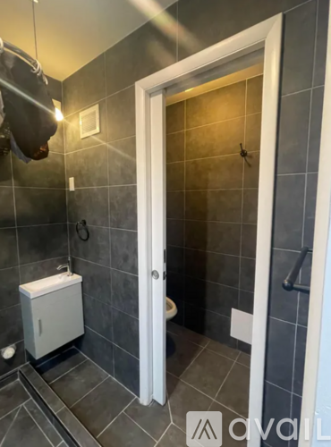 A bathroom with a toilet and a shower.