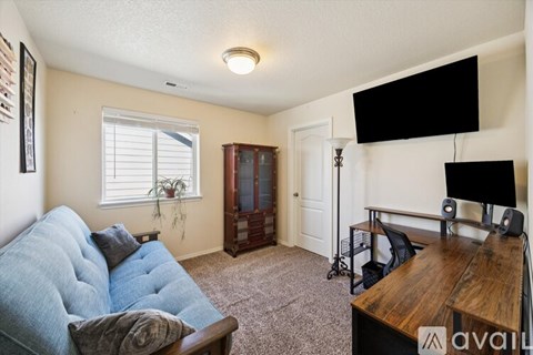 A living room with a blue couch and a wooden table.