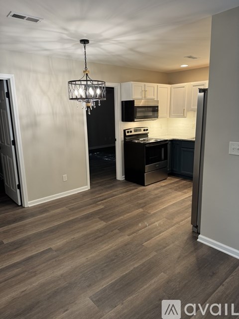 A kitchen with a black stove top oven and a black microwave.