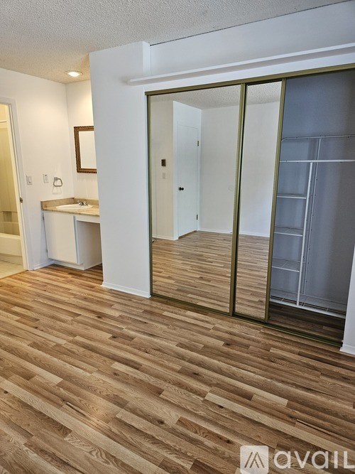 A room with a wooden floor and a white door.