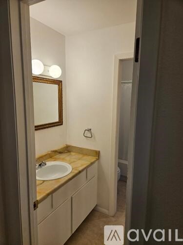 A bathroom with a sink and mirror.