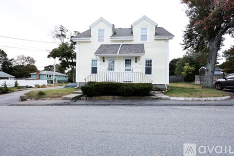 A white house with a black fence in front of it.