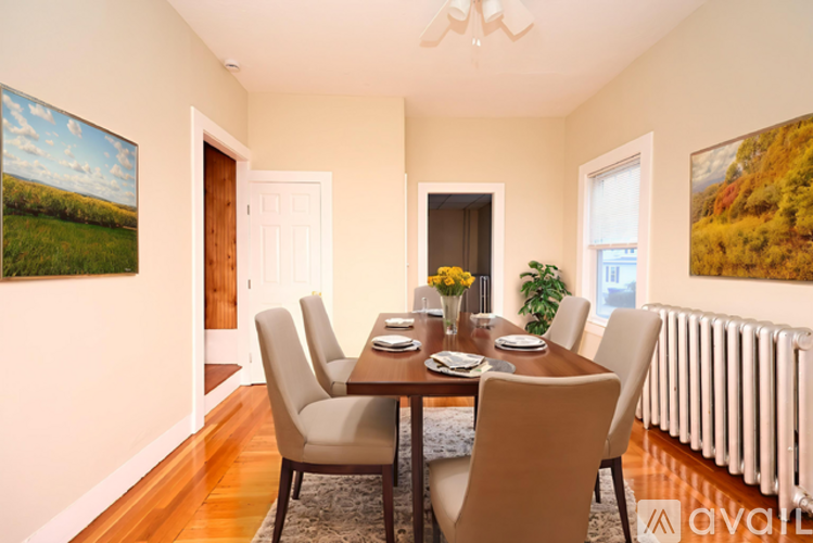 A dining room with a table set for six.