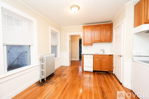 A kitchen with wooden cabinets and white appliances.