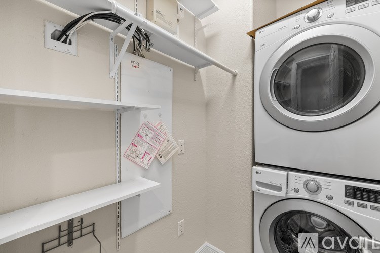 A washing machine is installed in a wall-mounted dryer rack.