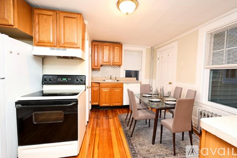 A kitchen with wooden cabinets and a black oven.