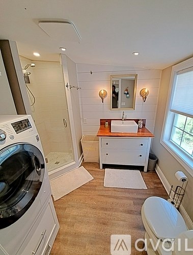 A small bathroom with a washer and dryer built in.