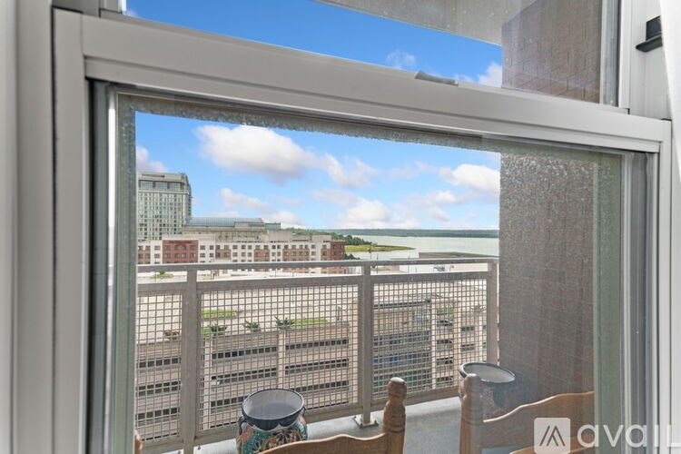 A view from a window looking out at a cityscape.