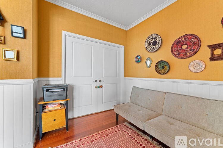 A room with a white door and a couch.