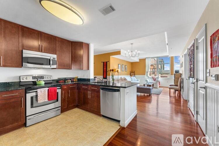 A kitchen with brown cabinets and a white dishwasher.