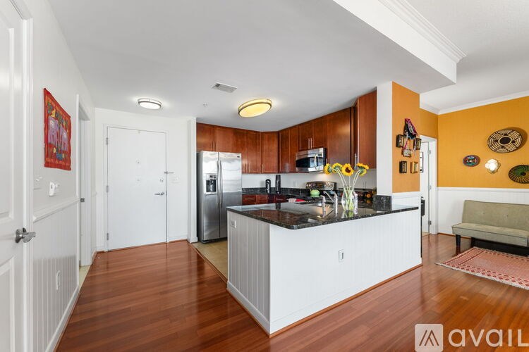 A kitchen with wooden floors and a white island.