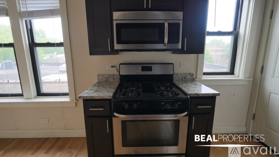 A kitchen with a stove top oven and microwave above it.