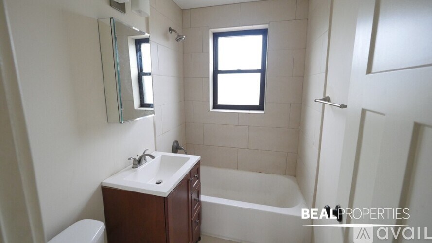 A white bathroom with a sink, toilet, and bathtub.