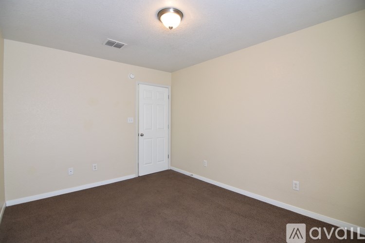 A room with a ceiling fan and a window.