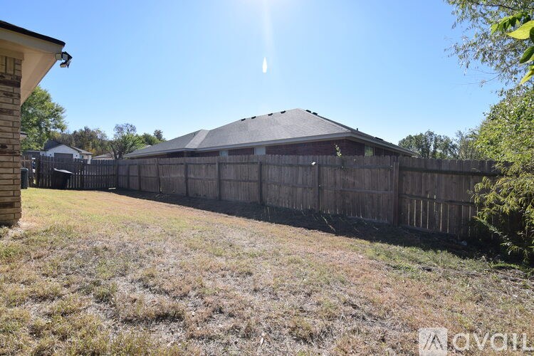 A kitchen area with a sink, stove, and cabinets.