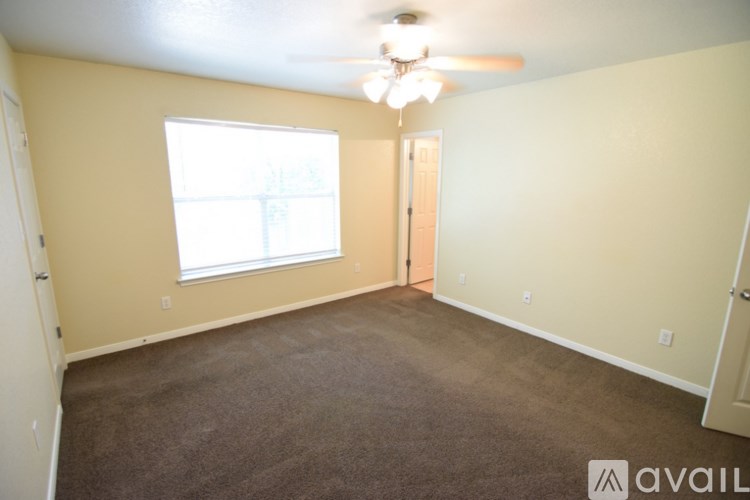 A room with a ceiling fan and a window.