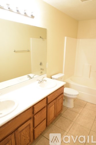 A bathroom with a white sink and toilet.