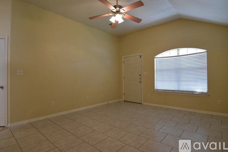 A room with a bench under cabinets and a door.