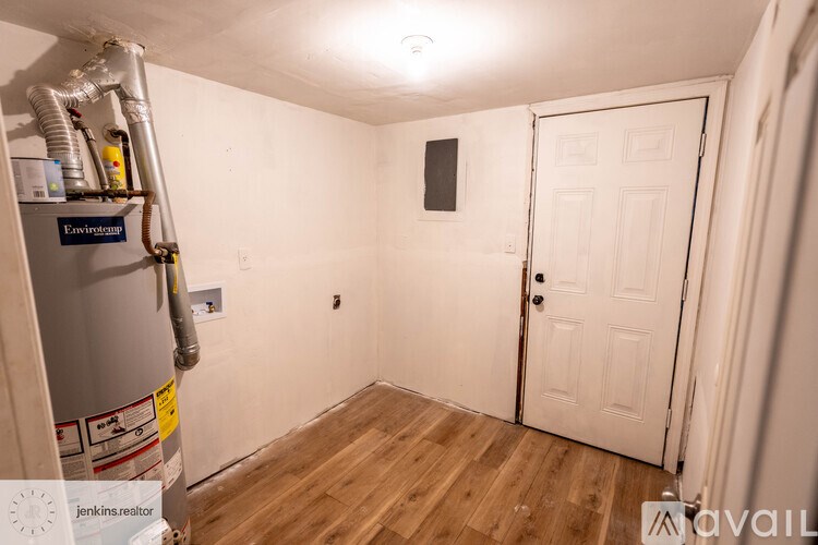 A room with a window and a wooden door.