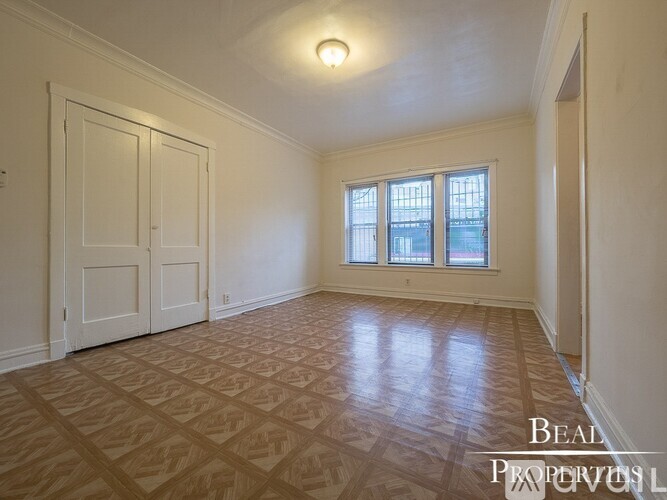 A room with a wooden floor and a window.