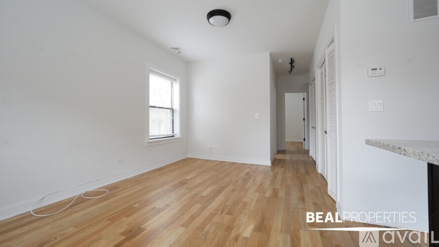 A room with wooden flooring and a window is available for rent.