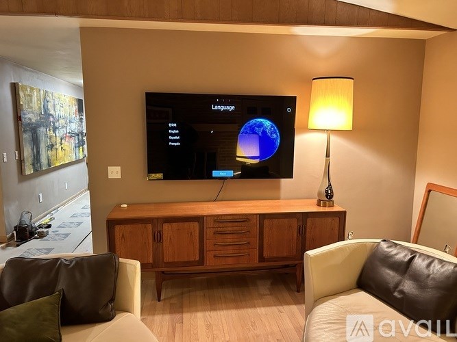 A living room with a television displaying the word "Language" and a globe graphic.