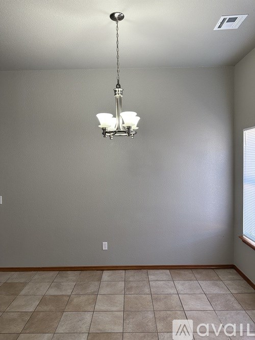 A room with a chandelier hanging from the ceiling.