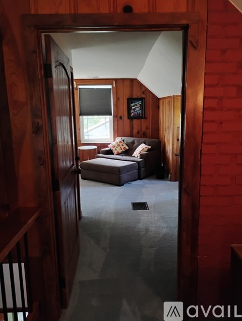 A living room with a couch and a window.