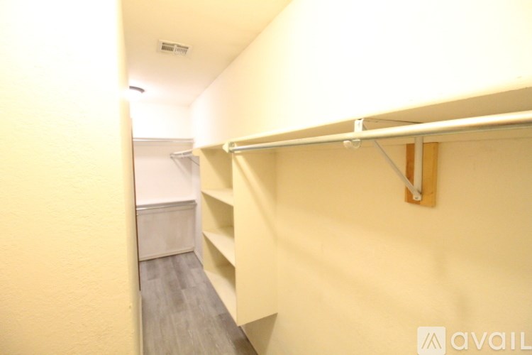 A long white shelf is mounted on a wall.