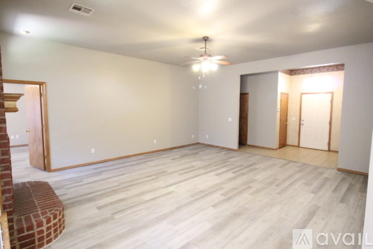 A room with wooden flooring and a ceiling fan.