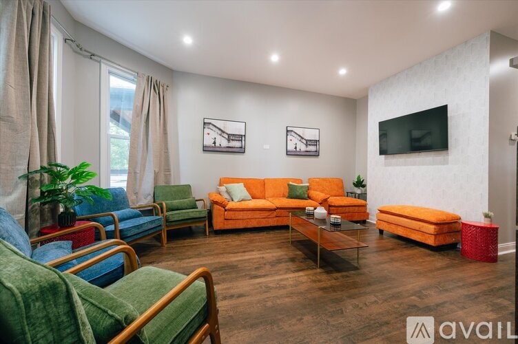 A living room with a green chair and a blue chair.