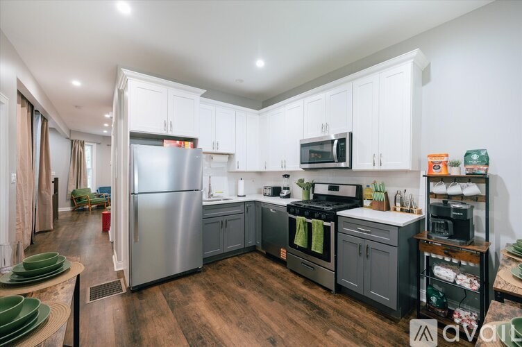 A kitchen with a refrigerator, oven, and microwave.