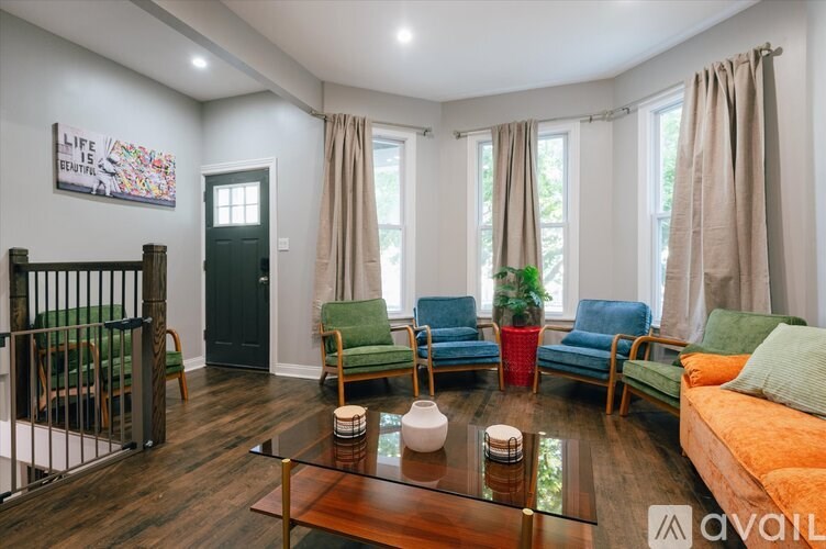 A living room with a glass table and a couch.