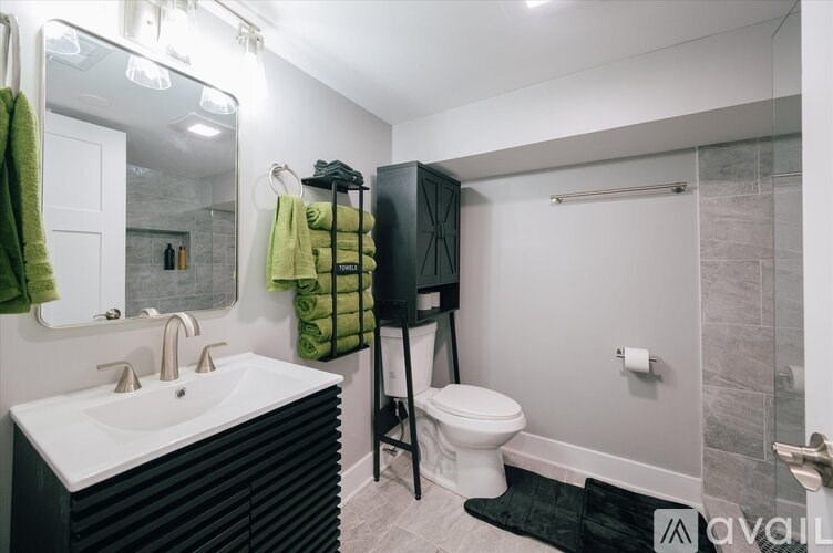 A bathroom with a white sink and a toilet.