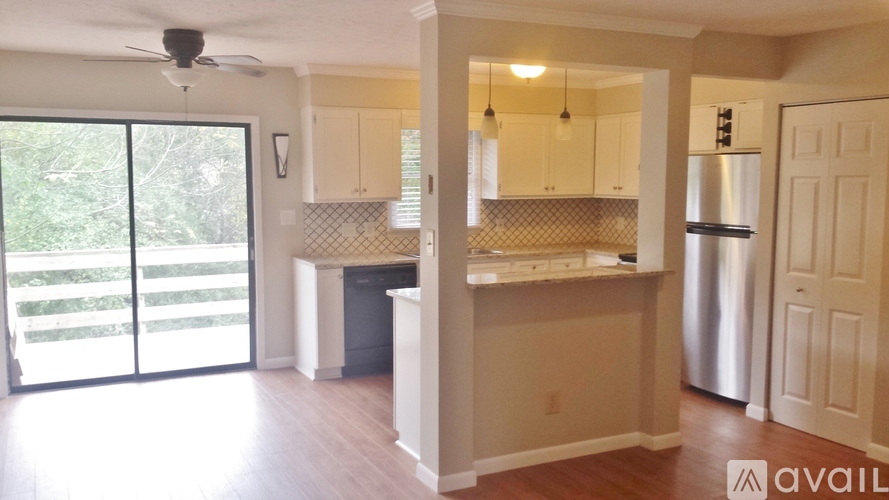 A kitchen with a refrigerator, sink, and cabinets is available for rent.