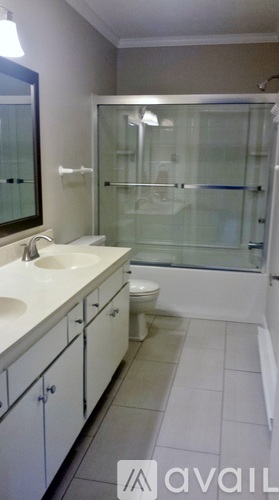 A bathroom with a sink, toilet and shower.