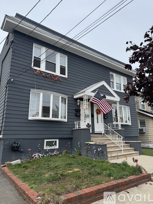 A house with a grey exterior and a white door.