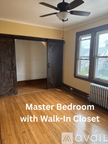 A room with a wood floor and a ceiling fan.