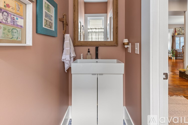 A bathroom with a sink and a mirror.