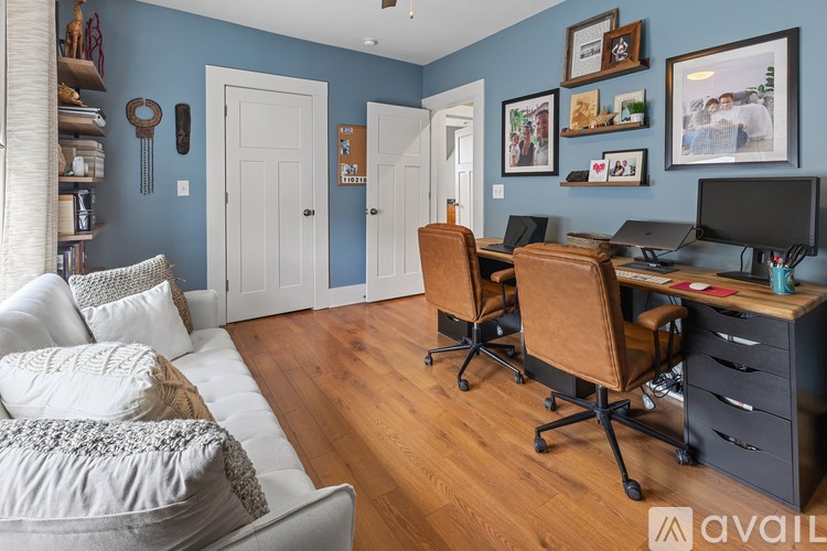 A room with a blue wall and a white door.