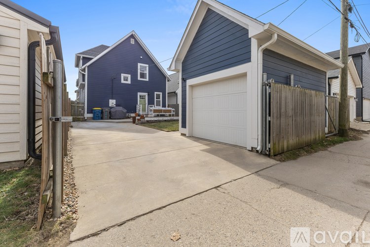 A blue house with a white garage door is available for rent.