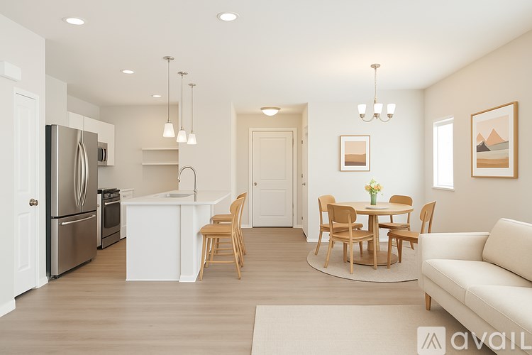 A modern kitchen with a dining table and chairs.