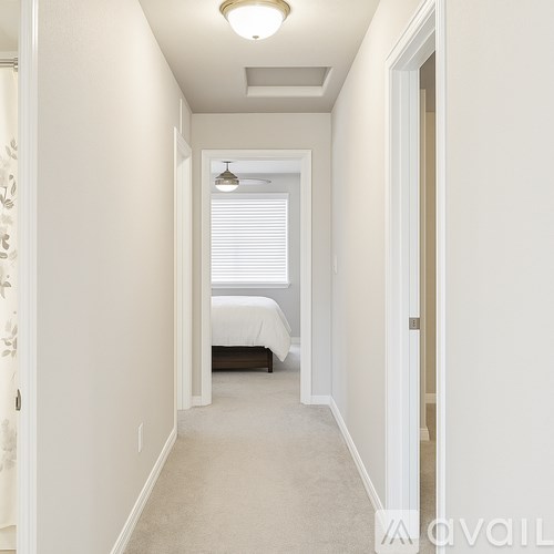 A long hallway with a bedroom at the end.