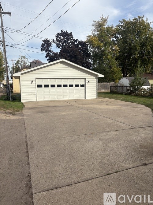 A two-car garage is situated in a driveway.