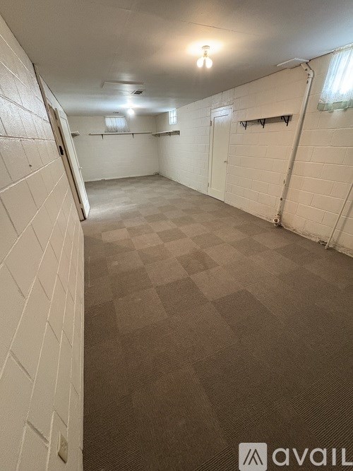 A spacious room with a checkered floor and white walls.