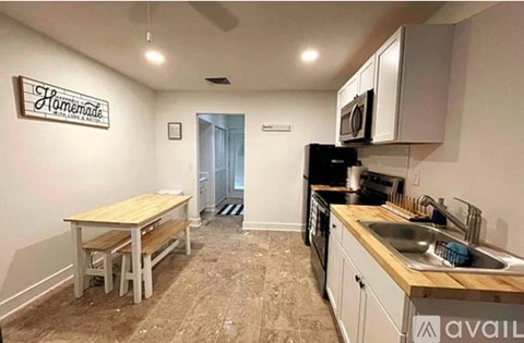 A kitchen with a wooden table and a sign that says "Homemade" on the wall.