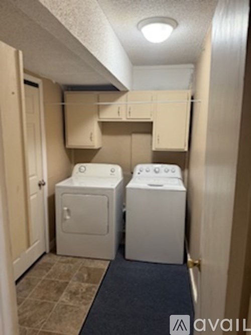A small laundry room with a washer and dryer.