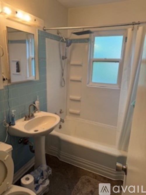 A bathroom with a sink, toilet, and bathtub.