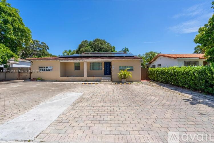 A house with a driveway in front of it.
